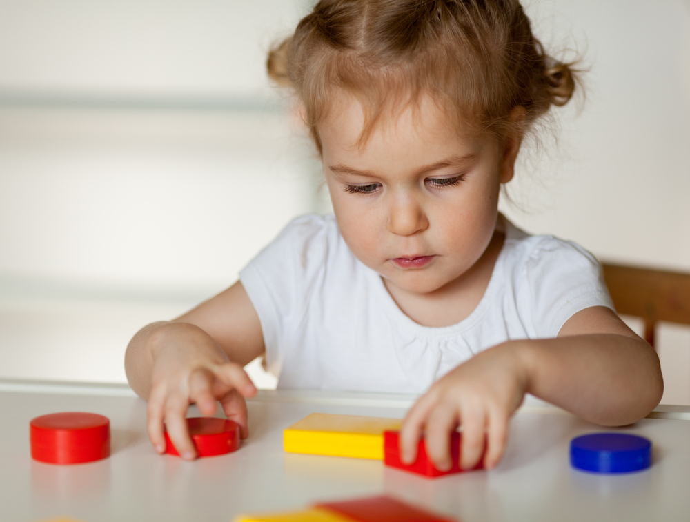 Juvenile Huntington's Disease | Huntington's Disease News | photo of girl playing with blocks