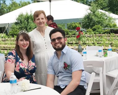 caregiver support | Huntington's Disease News | Alexus and René Sorina pose with Alexus' grandmother Edwina Jones at a wedding party at a winery. 