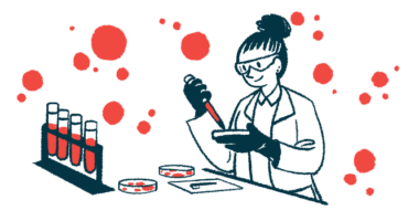 A scientist uses a dropper and petri dish to analyze blood samples in a lab.