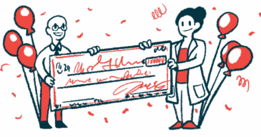 Two people in white coats hold an oversized check.