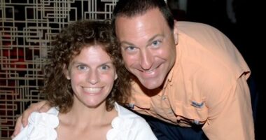 A woman and man smile in a portrait.