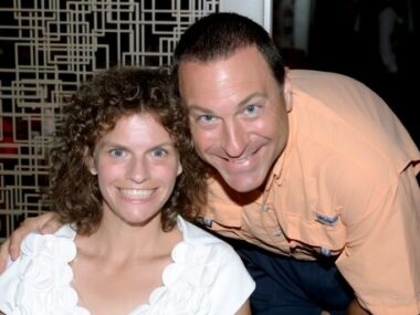 A woman and man smile in a portrait.