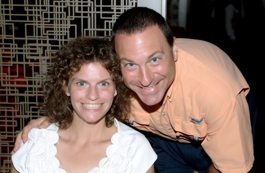 A woman and man smile in a portrait.